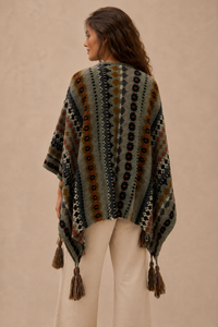 Nordic Grey Wrap worn as a shawl, back view showing the full fair isle motif and tassel fringe hem