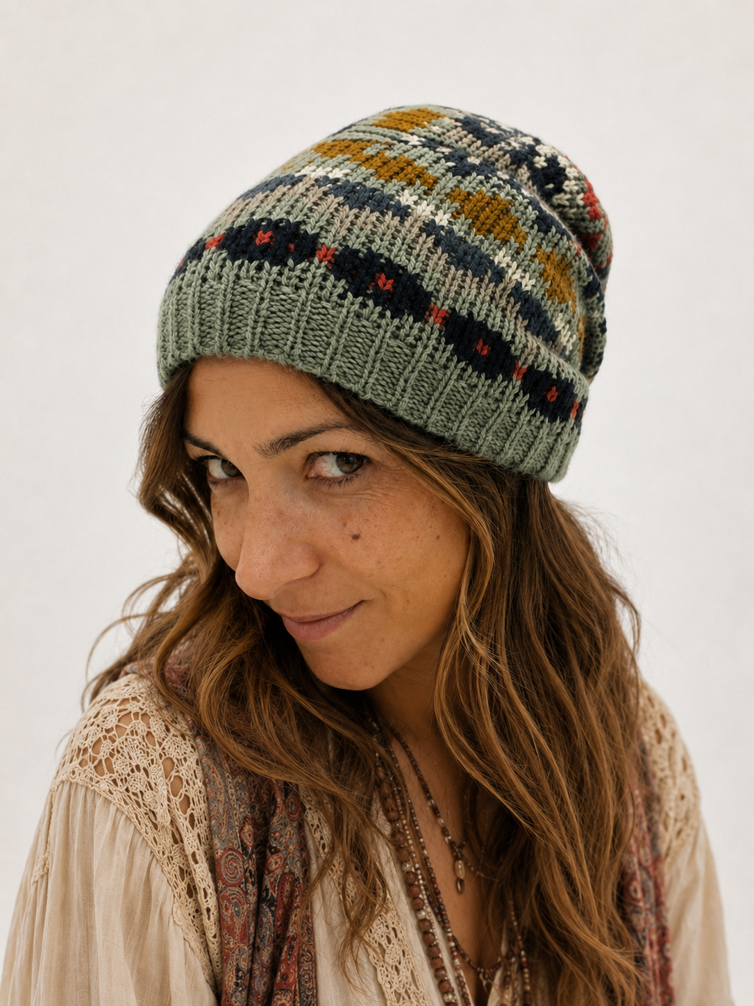 Nordic Grey Beanie in sage grey-green fair isle knit, side styled view showing slouchy crown and ribbed brim - Cienna Designs