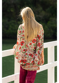 Ada Cape in pink floral silk viscose, back view showing the curved hem and floral border