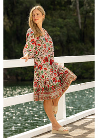 Ada Carmen Dress in pink floral cotton, second front view showing the gathered frill hem held out