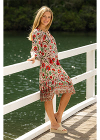Ada Carmen Dress in pink floral cotton, side view showing the knee-length skirt in motion