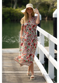 Ada Dress in pink floral cotton, front view showing the waist tie and side pockets