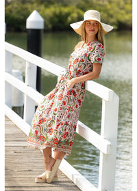 Ada Dress in pink floral cotton, side view showing the adjustable waist tie and flowing skirt