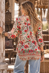 Ada Shirt in pink floral silk viscose, courtyard back view showing the curved hem and floral border