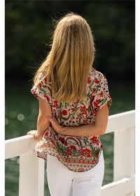 Ada Cuff Sleeve V Neck Top in pink floral cotton, back view showing the curved hem