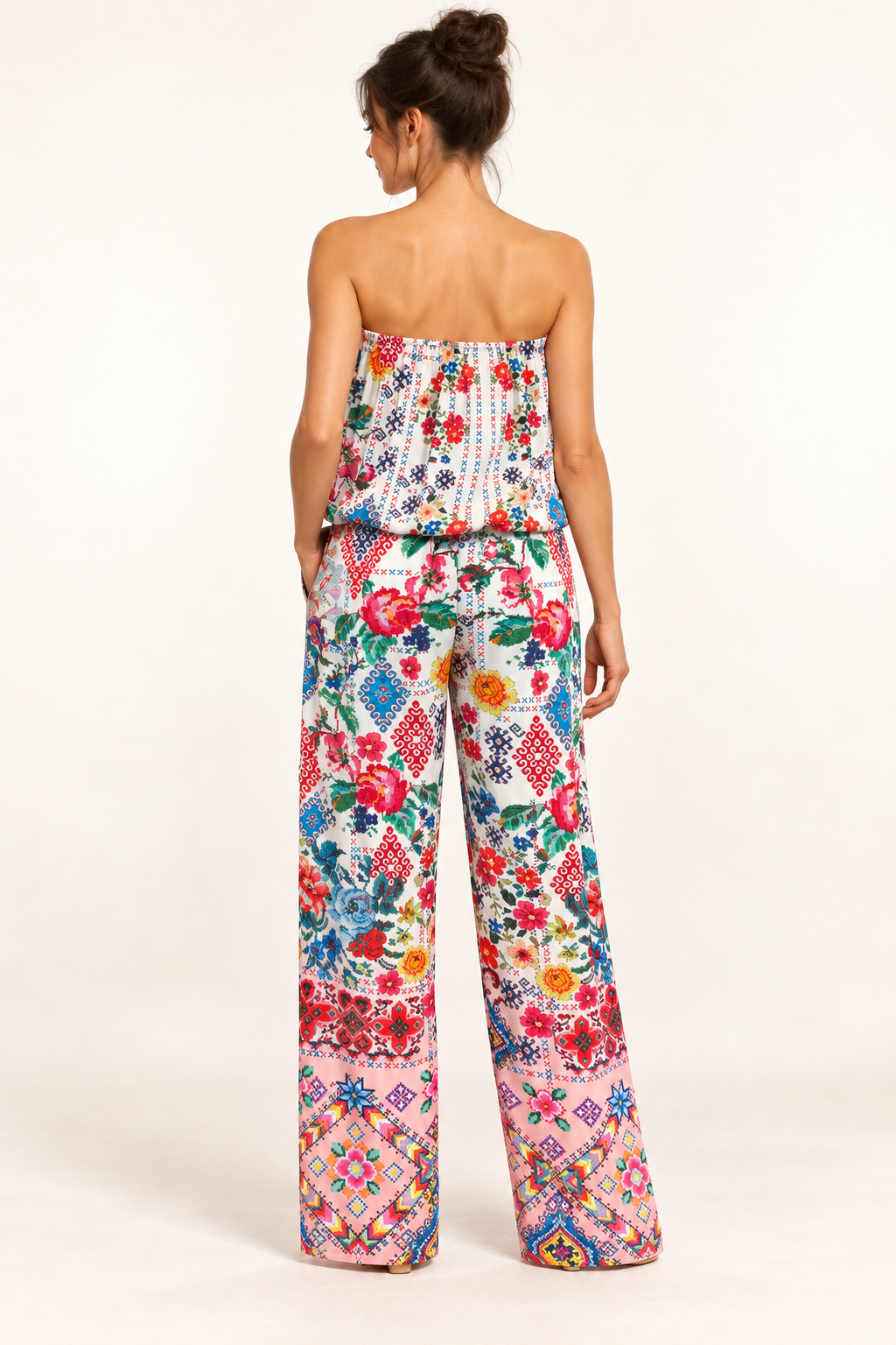 Cita Jumpsuit in ivory floral and geometric print viscose rayon, back studio view with a blouson bodice and pink borders