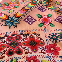 Cita Jumpsuit in floral and geometric print viscose rayon, close view of the fabric with pink borders and blue star motifs