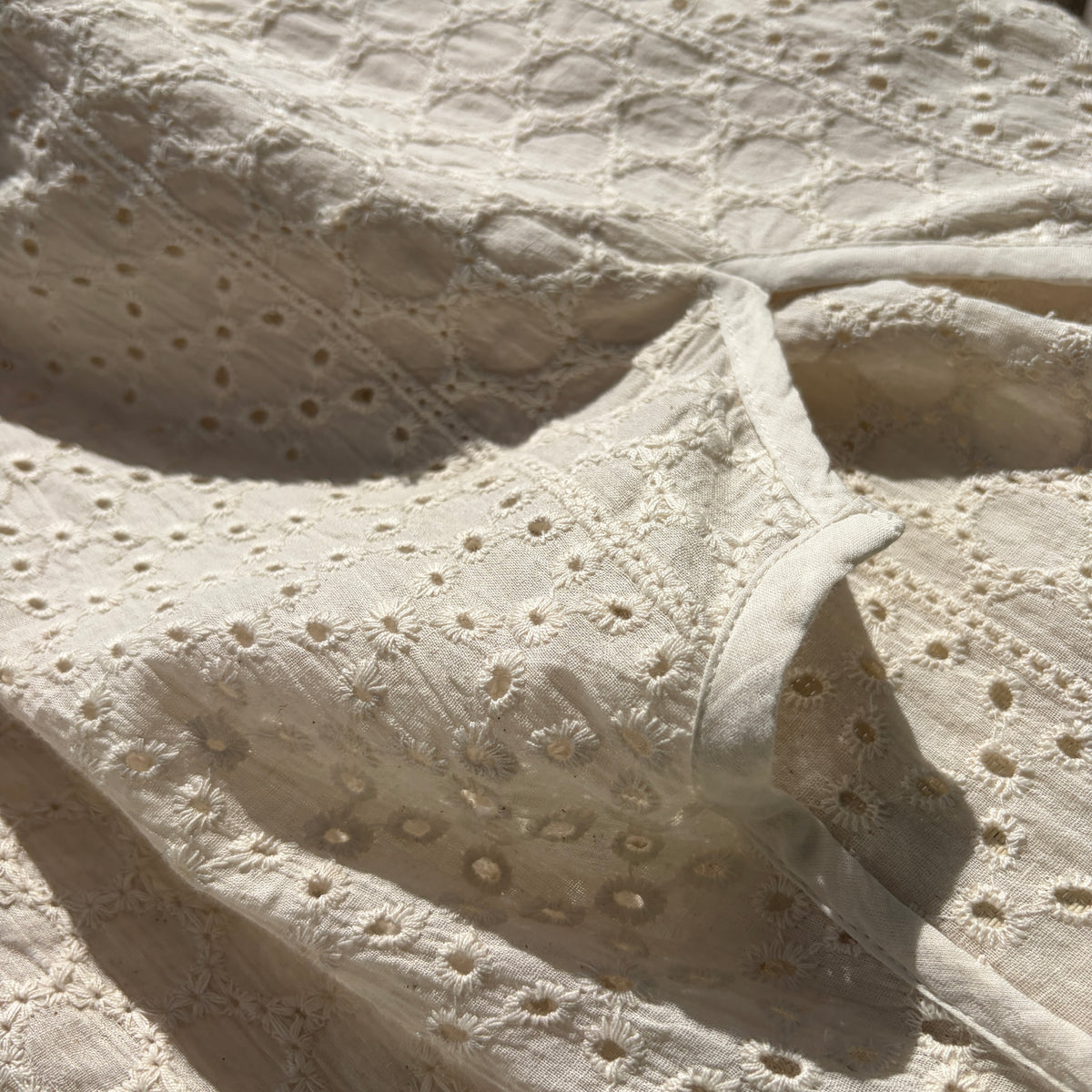 CJ-117 Top in natural cream, close view of the notched neckline and oval eyelet embroidery