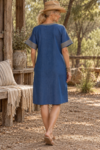 CJ-12 Egyptian Denim Dress in indigo, back view showing the plain back and pale gold embroidered neckline and sleeves