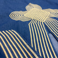 CJ-12 Egyptian Denim Dress, close view of indigo fabric and raised pale gold geometric embroidery around the neckline and sleeve border