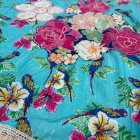 CJ-165 Bird Long Dress in turquoise blue cotton, close view of the parrot print, floral appliqués, embroidery and cream lace trim