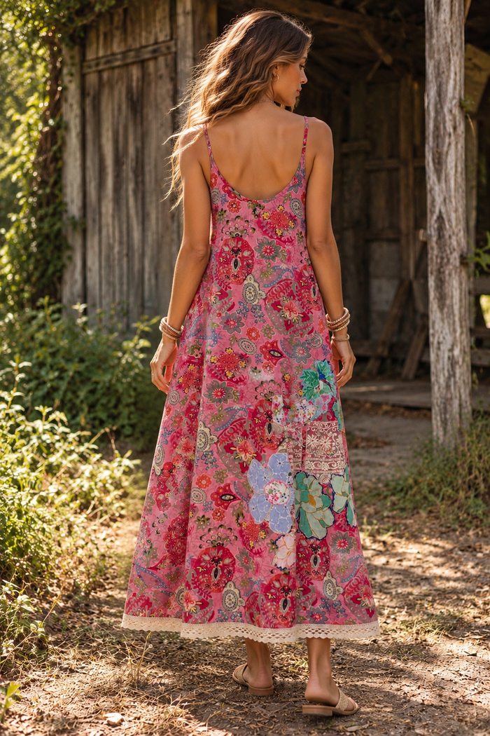 Back view of the CJ-165 Floral Long Dress in pink, showing its scoop back, slender straps and flowing floral skirt