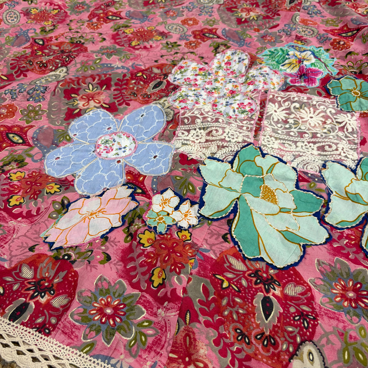 Close-up of the CJ-165 Pink Floral Long Dress showing mixed floral panels and cream lace trim