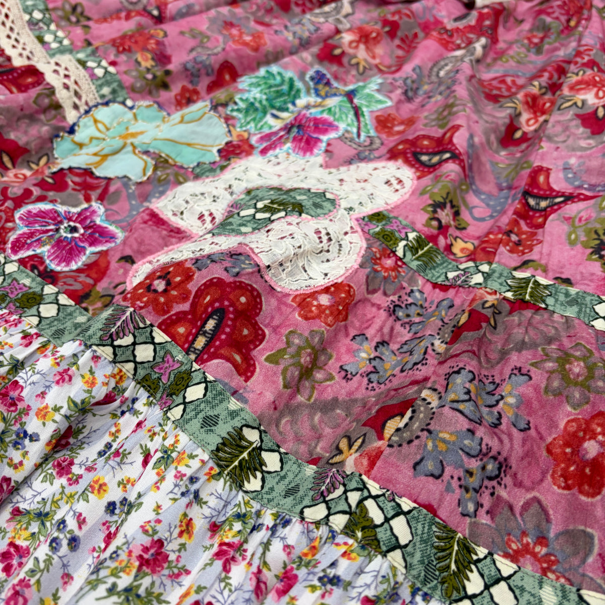 CJ-167 Floral Skirt - Pink, detail of aqua and magenta floral appliqué, cream lace and green patterned borders