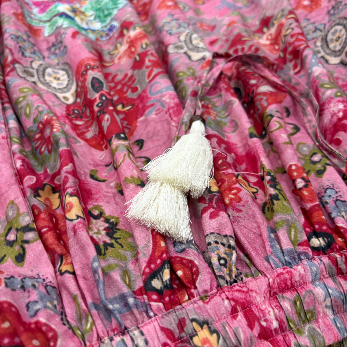 CJ-167 Floral Skirt - Pink, close-up of the elasticated waistband and printed ties with ivory tassels and brown beads