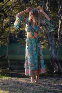 Dee Top in blue and hot pink printed silk blend, second arms-raised view showing the flared sleeves and matching skirt