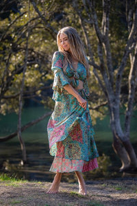 Dee Top in blue and hot pink printed silk blend, angled front view showing the sleeve drape, worn with a matching skirt