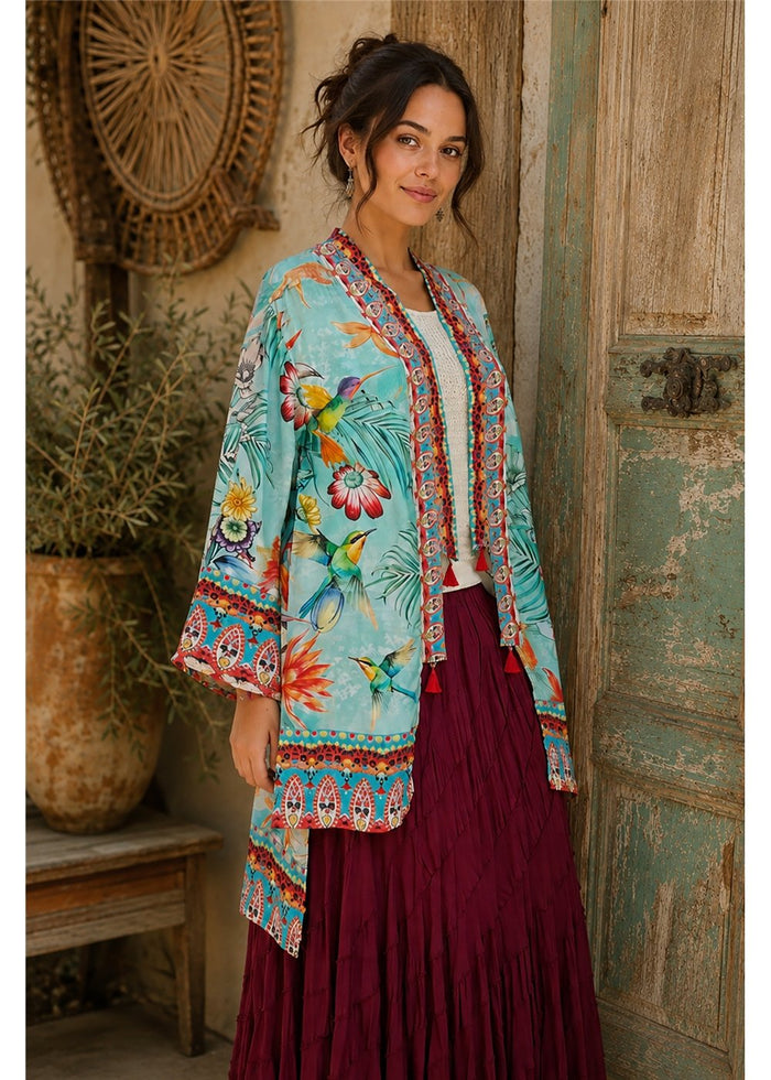 Hummingbird Kimono in aqua silk viscose, front view worn open with a wide sleeve and an ornate band down each edge