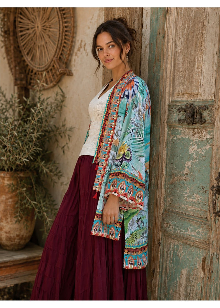 Hummingbird Kimono in aqua silk viscose, side view showing the long line to the thigh and the bordered cuff