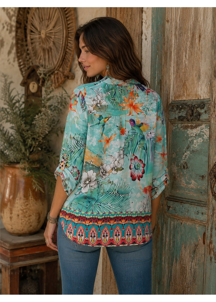 Hummingbird Shirt in aqua silk viscose, back view showing the curved hem and its ornate border