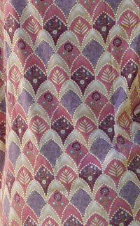 Close view of Salma silk-blend fabric with pink and plum leaf and floral motifs and gold accents