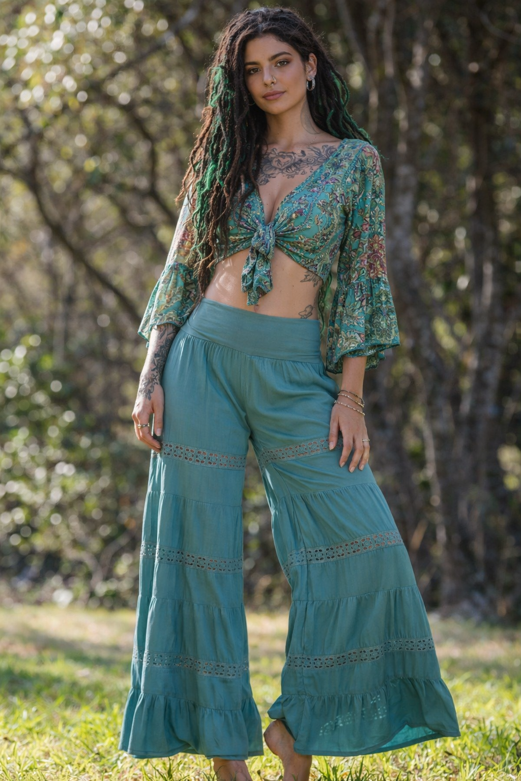 Tropez Pants in seafoam rayon voile, outdoor front view showing the folded waistband and flared legs, worn with the Dee Top