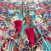 Turquoise Rhapsody Frill Dress, a blue floral and paisley viscose rayon dress, close-up of the neckline tassel ties.