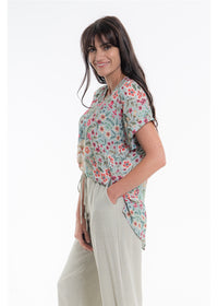 Vintage Blossom V-Neck Top in blue-grey floral viscose linen, side view showing the curved hem