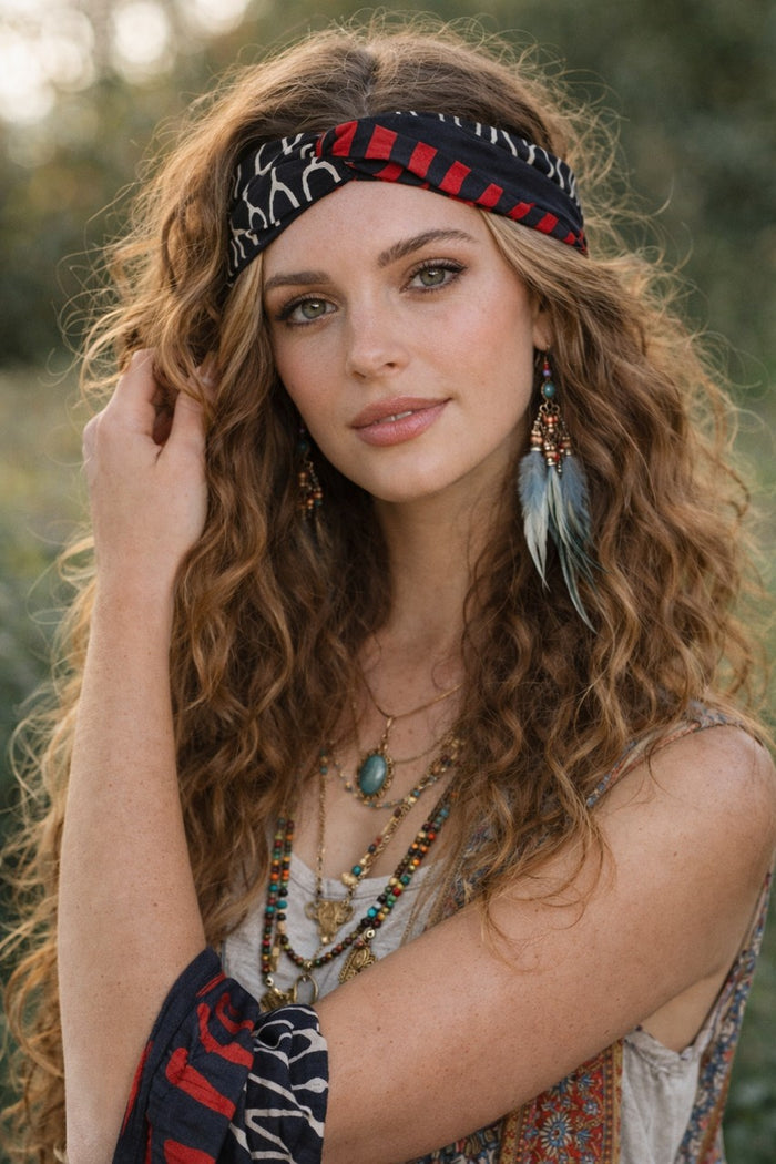 Yindi Cotton Headband in black, red and cream geometric cotton, second front view showing the wide band with hair worn loose