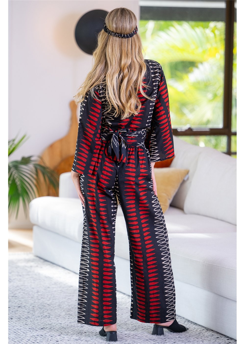 Yindi Cotton Hemi Pant in black, red and cream geometric cotton, second back view showing the straight, full-length legs