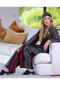 Yindi Cotton Hemi Pant in black, red and cream geometric cotton, seated view showing the loose leg shape and drape