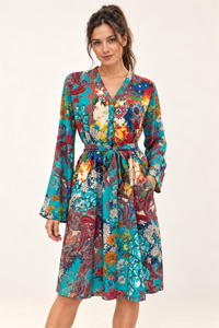 Zahara Dress in turquoise floral and paisley print, studio front view showing the tied waist and long sleeves.