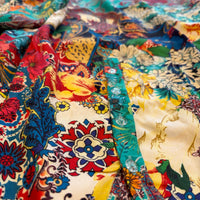 Zahara Dress in turquoise, red, yellow and ivory floral print, close view of the button placket.