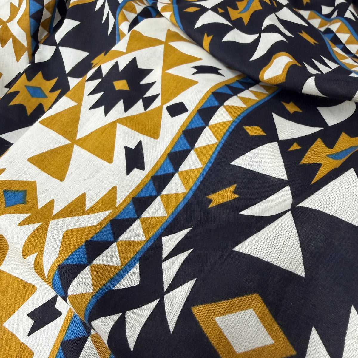 Coyote collection fabric swatch for Dakota skirt showing navy base with bold gold mustard and cream geometric pattern - Cienna Designs