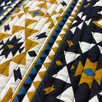Coyote geometric quilted vest additional view in navy base with bold gold mustard geometric motifs - Cienna Designs