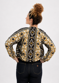 Coyote geometric print reversible bomber jacket back view showing navy base with high contrast gold mustard geometric pattern - Cienna Designs