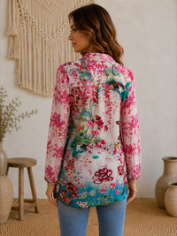 Lotus Love shirt side view showing curved high-low hem and roll-tab sleeves in colourful semi-sheer floral silk-viscose - Cienna Designs