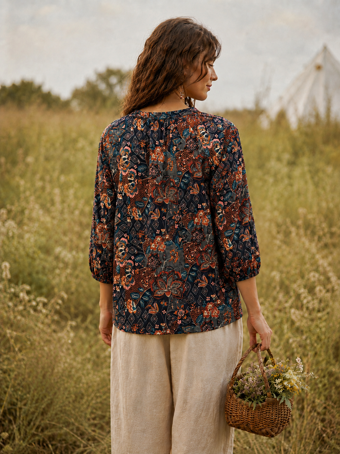 Midnight Folk embroidered blouse back view in deep navy rayon with folk floral print and three-quarter flared sleeves with lace-trim cuffs - Cienna Designs