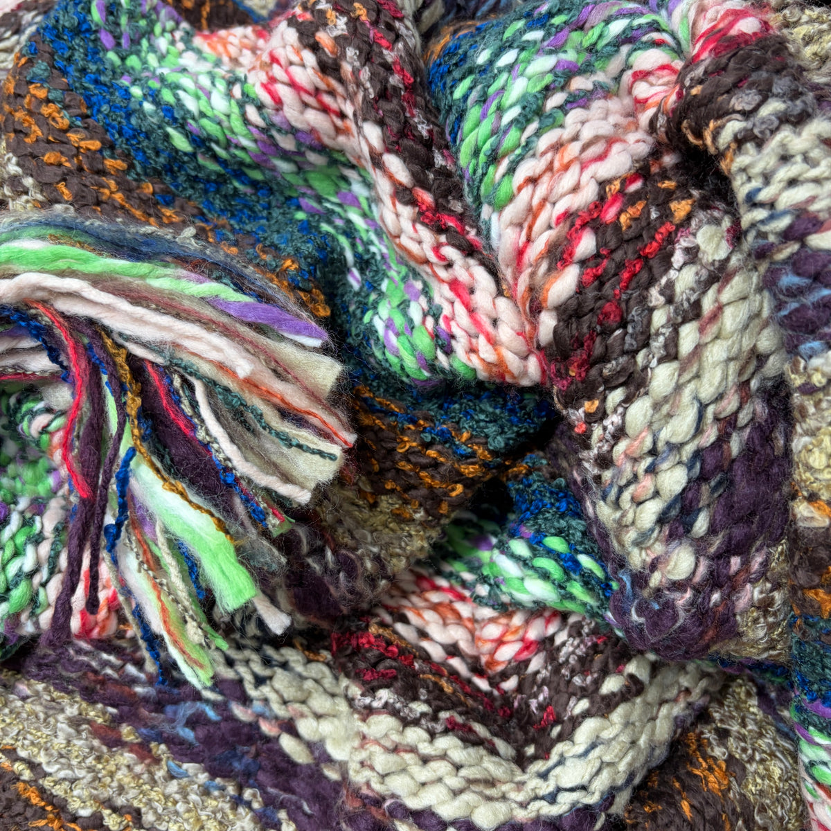 Close-up of Nia Neon Turtleneck Poncho showing vibrant blue and green knit texture - Cienna Designs
