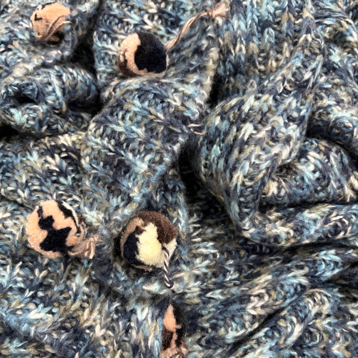 Pompom Wrap blue colour way fabric closeup with black white pompom tassels