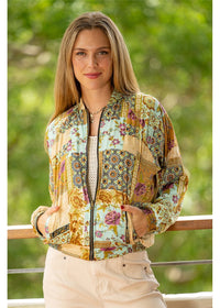Sherwood Reversible Bomber reverse side in vibrant teal with blooming florals in rust, burgundy and purple — Cienna Designs