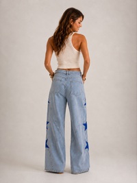 Star Pearl Denim Jeans Light Wash - back view showing wide-leg silhouette and blue star appliqués on light wash denim