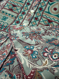 Close-up of Willow Paisley dress embroidered front panel showing delicate paisley and floral motifs - Sample D-1528 by Cienna Designs